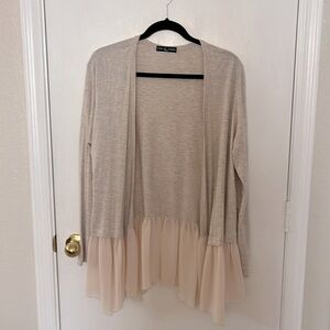 Super soft feminine beige cotton sweater with hem ruffle detail